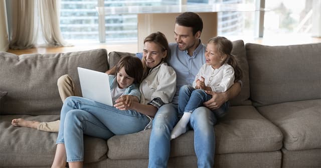 Happy-little-children-and-cheerful-mother-and-father-watching-funny-family-movie